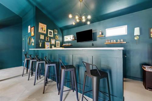 a bar with a bunch of stools in a room at The Luxe Hot Tub Private Bar 12 Min to Horse Park in Georgetown