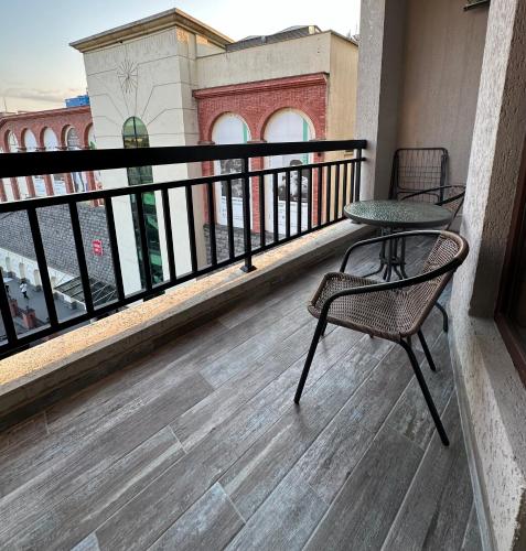 a balcony with two chairs and a table at Home M&M in Kutaisi