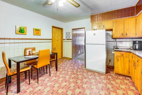 a kitchen with a table and a white refrigerator at Ottawa Home with Porch, Near Starved Rock State Park in Ottawa