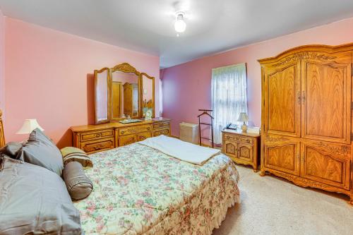 a bedroom with a bed and a dresser and a mirror at Ottawa Home with Porch, Near Starved Rock State Park in Ottawa