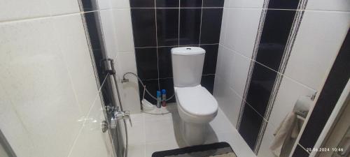 a bathroom with a white toilet in a room at Kuki house in Ganja
