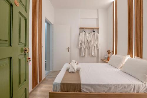 a bedroom with a bed with a green door at Vincenzo Harmony II- Rethymno old town in Rethymno Town