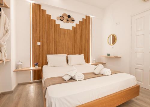 a bedroom with a large white bed with white pillows at Vincenzo Harmony II- Rethymno old town in Rethymno Town