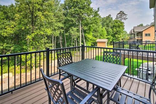 a table and chairs on a deck with a fence at New Gull Lake Townhome! 5 bed 3200ft and Boat Slip in Nisswa