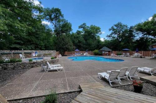 a patio with lounge chairs and a swimming pool at New Gull Lake Townhome! 5 bed 3200ft and Boat Slip in Nisswa