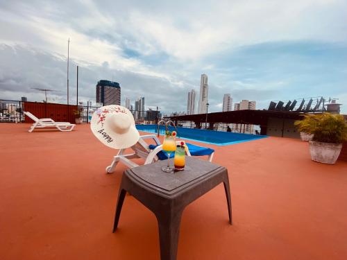 a person sitting in a chair on top of a roof at Hotel Caribe Panamá in Panama City