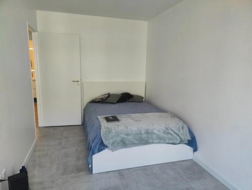 une chambre avec un lit dans une pièce blanche dans l'établissement Confortable 54m2 NEW Paris Nation Gare de Lyon, à Paris