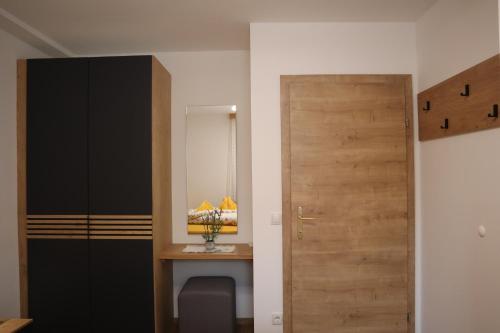 a room with a desk and a wooden door at Landhaus-Appartements Warraich in Schladming