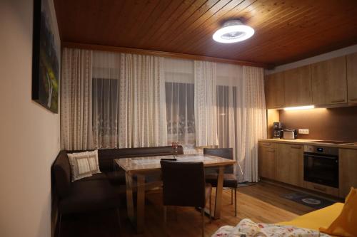 a kitchen and dining room with a table and chairs at Landhaus-Appartements Warraich in Schladming