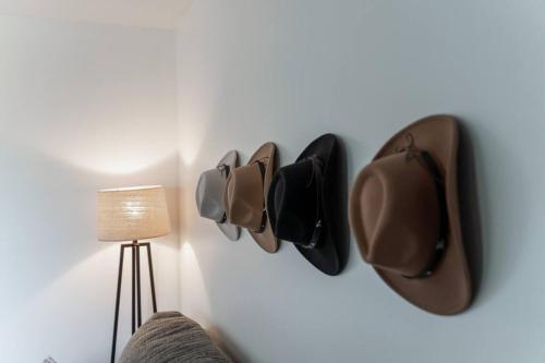 a wall with three hats hanging on a wall at Amazing pool, Steps 2 Broadway right on the Riverfront! in Nashville