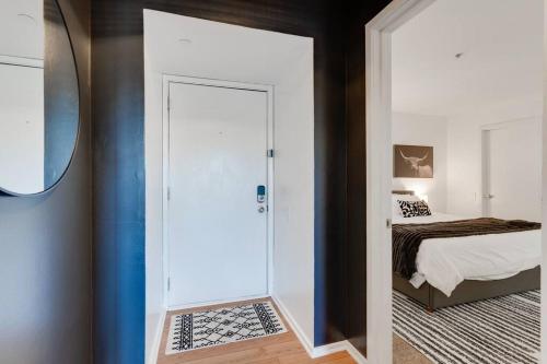 a bedroom with a door leading to a bed at Amazing pool, Steps 2 Broadway right on the Riverfront! in Nashville