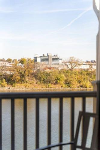 a balcony with a view of a body of water at Amazing pool, Steps 2 Broadway right on the Riverfront! in Nashville