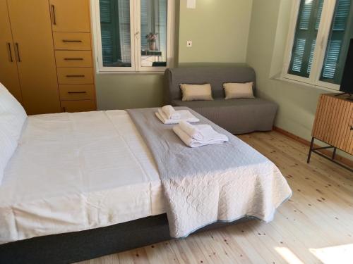 a bedroom with a bed with two towels on it at 1920 Classic in Kalamata