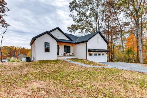 a white house with a black roof at The Birdhouse - Lake View with Dock in Mooresville