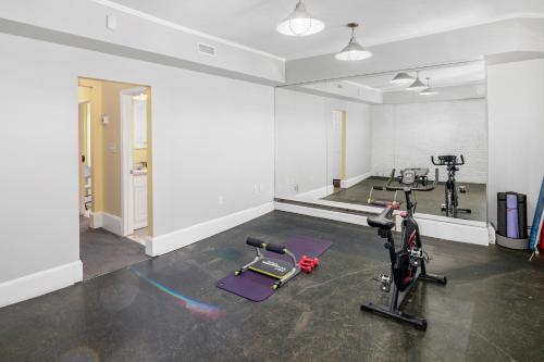 a gym with two treadmills and two exercise bikes at Brownstone Townhouse in Fenway in Boston
