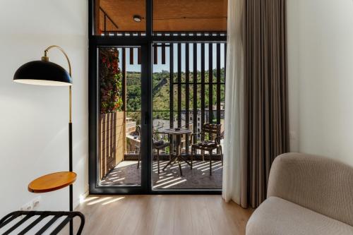 a living room with a door open to a patio at Solridge Aparthotel in Tbilisi City