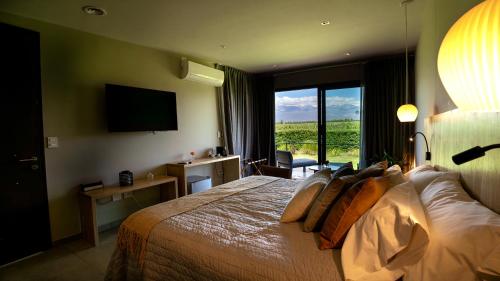a hotel room with a bed and a large window at Casa de Huéspedes La Azul in Los Árboles