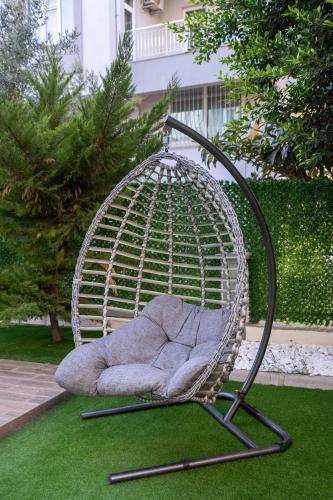 a swing chair sitting on the grass in a yard at Sorta Hotel in Antalya