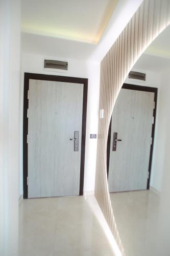 an empty hallway with two doors in a building at Lux Apartmani Teslić in Teslić