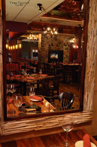 a mirror in a restaurant with a table and chairs at Centerstone Plaza Hotel Soldiers Field - Mayo Clinic Area in Rochester