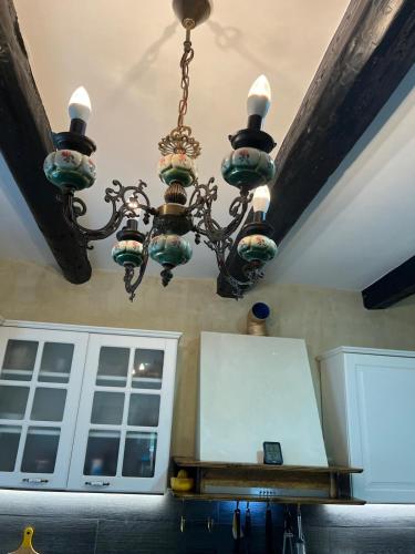 a chandelier hanging from a ceiling in a kitchen at Seoska rapsodija in Tršće