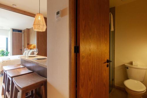 a bathroom with a toilet and a table and a sink at Hermoso Estudio frente al mar, Zantamar 304 in Cruz de Huanacaxtle
