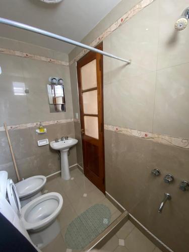 a bathroom with a toilet and a sink and a shower at Casa en centro salteño in Salta