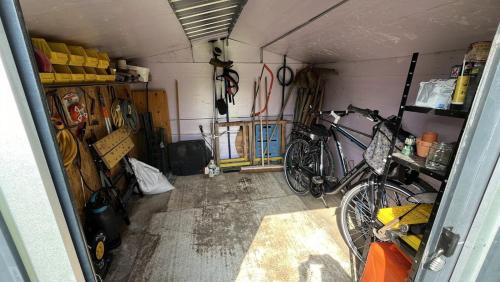 a garage with a bike parked in a room at Chez Béné in Rochefort