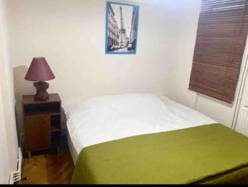 a bedroom with a bed and a table with a lamp at Panoramik deniz manzaralı dubleks in Adalar