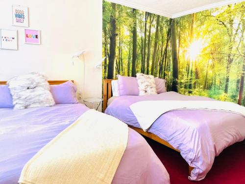 two beds in a room with a window with trees at Lotus Family Suite w 2 Beds Kitchenette 4 in Shandaken