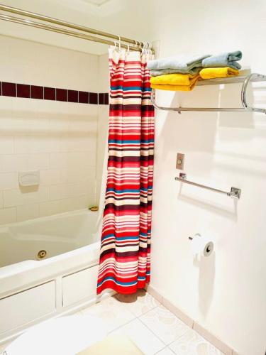 a bathroom with a red and white shower curtain at Lotus Family Suite w 2 Beds Kitchenette 4 in Shandaken