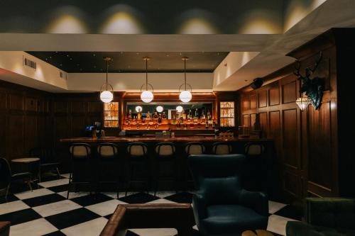 a bar in a restaurant with a checkered floor at The St. Clair in Frankfort