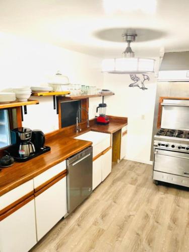 a kitchen with white cabinets and a stove at Guest Favorite Garuda Apartment 8 in Shandaken