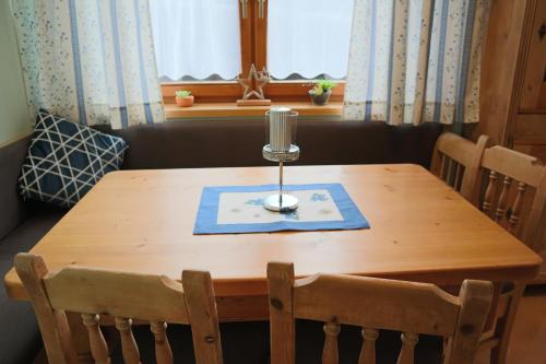 a wooden table with a candle on top of it at Landhaus-Appartements Warraich in Schladming