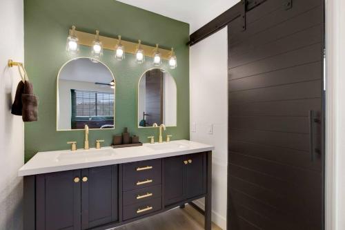 a bathroom with a sink and a mirror at Lux Fun Zone Home - Sleeps 16 in Mesa