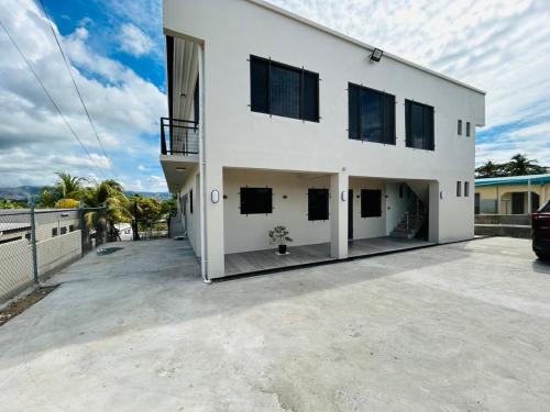 a large white house with a parking lot at VNZ Luxury Apartment in Mba