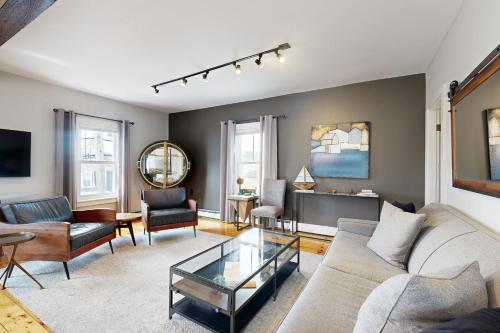 a living room with a couch and a table at Snug Harbor II in Boothbay Harbor