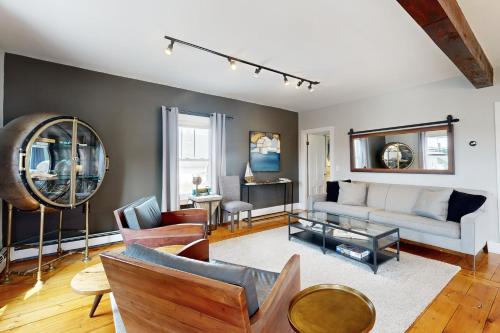 a living room with a couch and a table at Snug Harbor II in Boothbay Harbor
