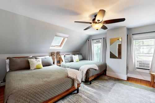 a bedroom with a bed and a ceiling fan at Snug Harbor II in Boothbay Harbor