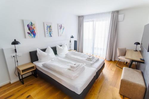 a hotel room with two beds and a window at Helios Berlin Apartments in Berlin