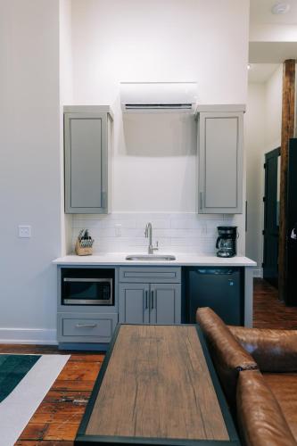 a kitchen with blue cabinets and a sink and a couch at The St. Clair in Frankfort