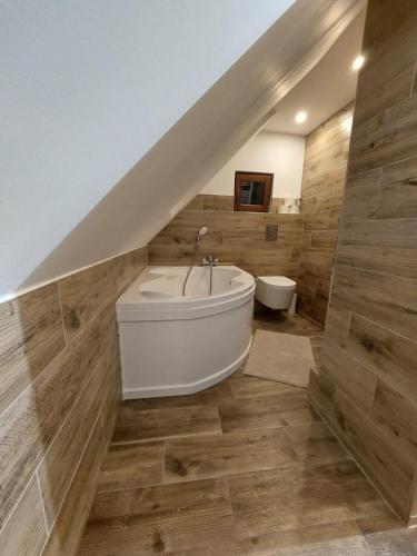 a bathroom with a white tub and a sink at Keramika Rokytnice in Rokytnice nad Jizerou