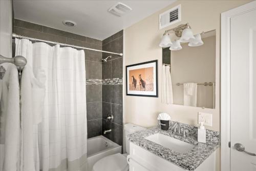 a bathroom with a sink and a toilet and a shower at Your Unique Desert Compound - Amenities Galore in Peoria