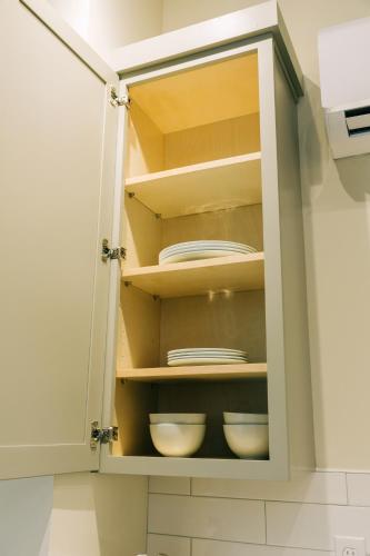 a cupboard with plates and dishes in it at The St. Clair in Frankfort