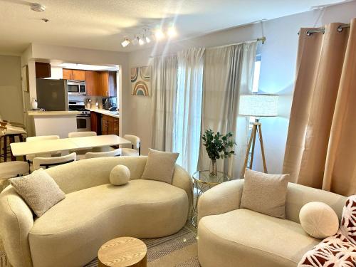 a living room with two couches and a kitchen at Mid-City Charm 2BR Near LAs Hotspots! in Los Angeles