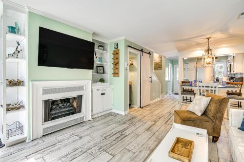 a living room with a fireplace and a flat screen tv at Chic Murrells Inlet Getaway about 2 Mi to Marsh Walk! in Myrtle Beach