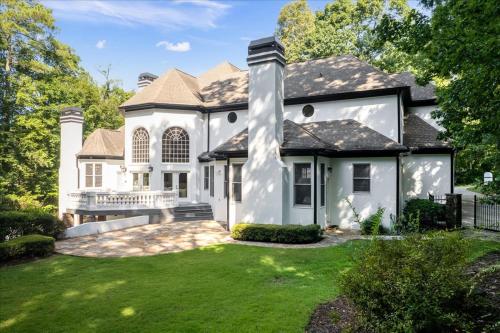 a white house with a yard with green grass at 11580sqft Large Home By Airport in Atlanta