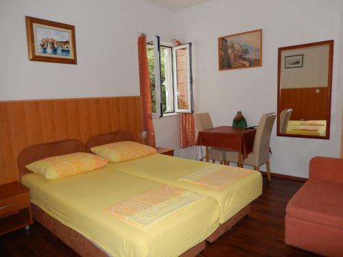 a bedroom with a bed and a table and a chair at Amazing sea view apartments in Dubrovnik
