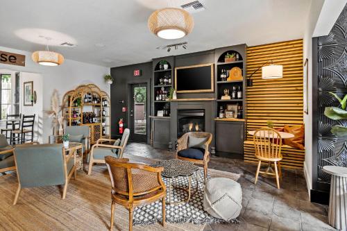 a living room with a fireplace and a table and chairs at Peri Social House in Black Mountain