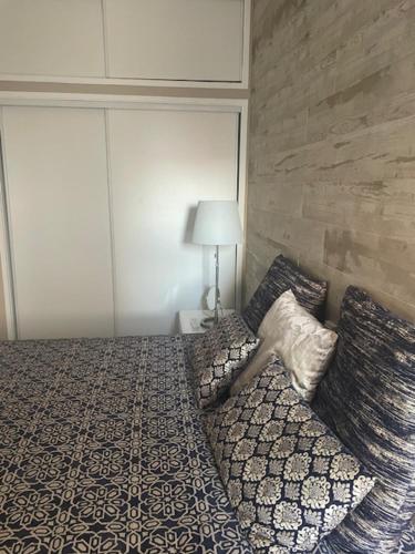 a bedroom with a bed with a pillow on it at Apartamento ARMAÇÃO PÊRA in Armação de Pêra